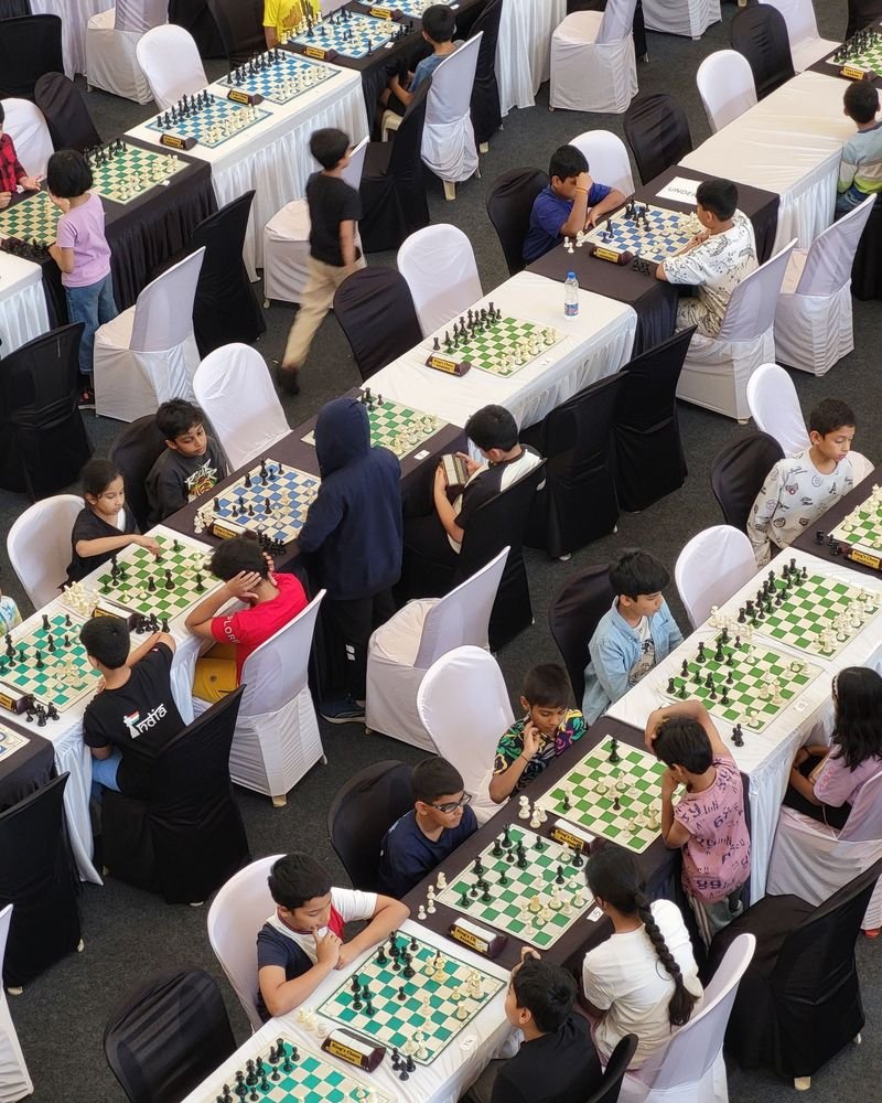 Rows of children playing chess in a large tournament hall – Largest Chess Tournament world record idea