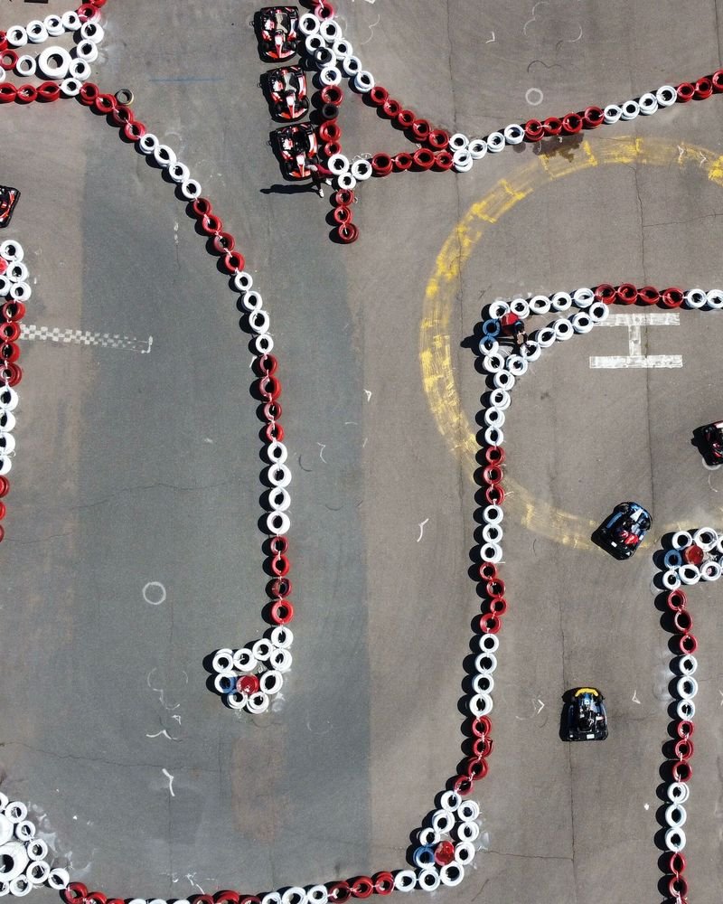 An aerial view of go-karts racing on a track marked out with red and white tyres – Go-Kart Endurance Race world record idea